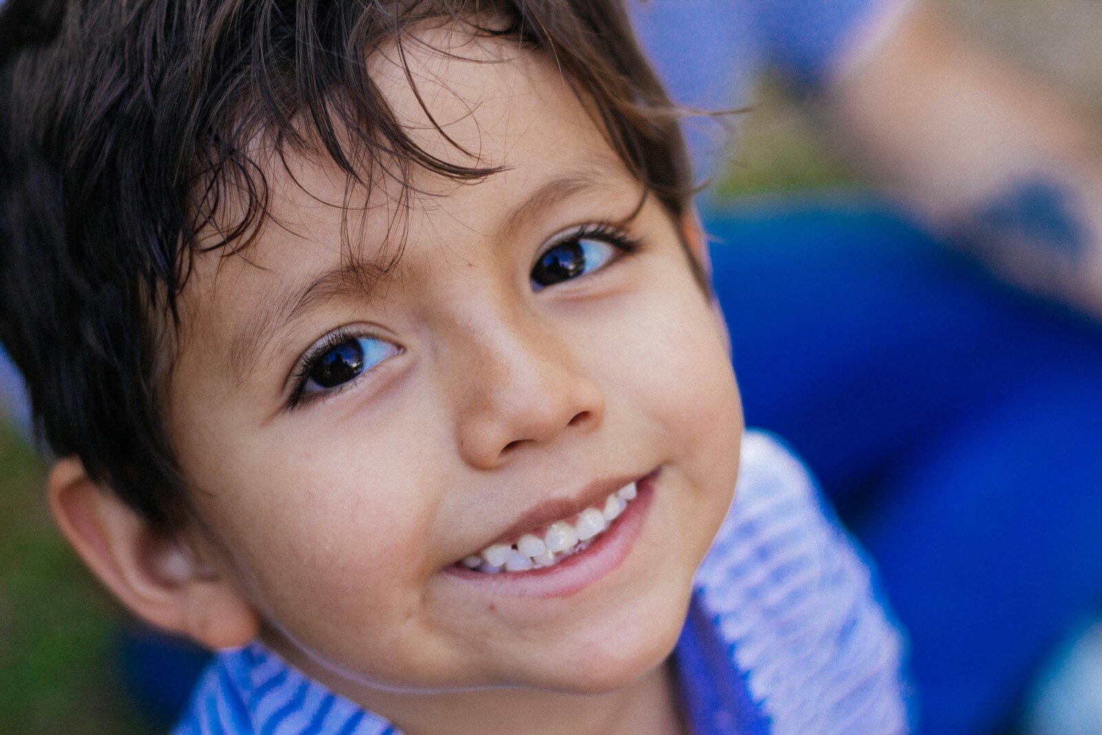 a close up of a child smiling at the camera